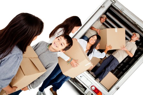 Insured man with van service handling household items carefully